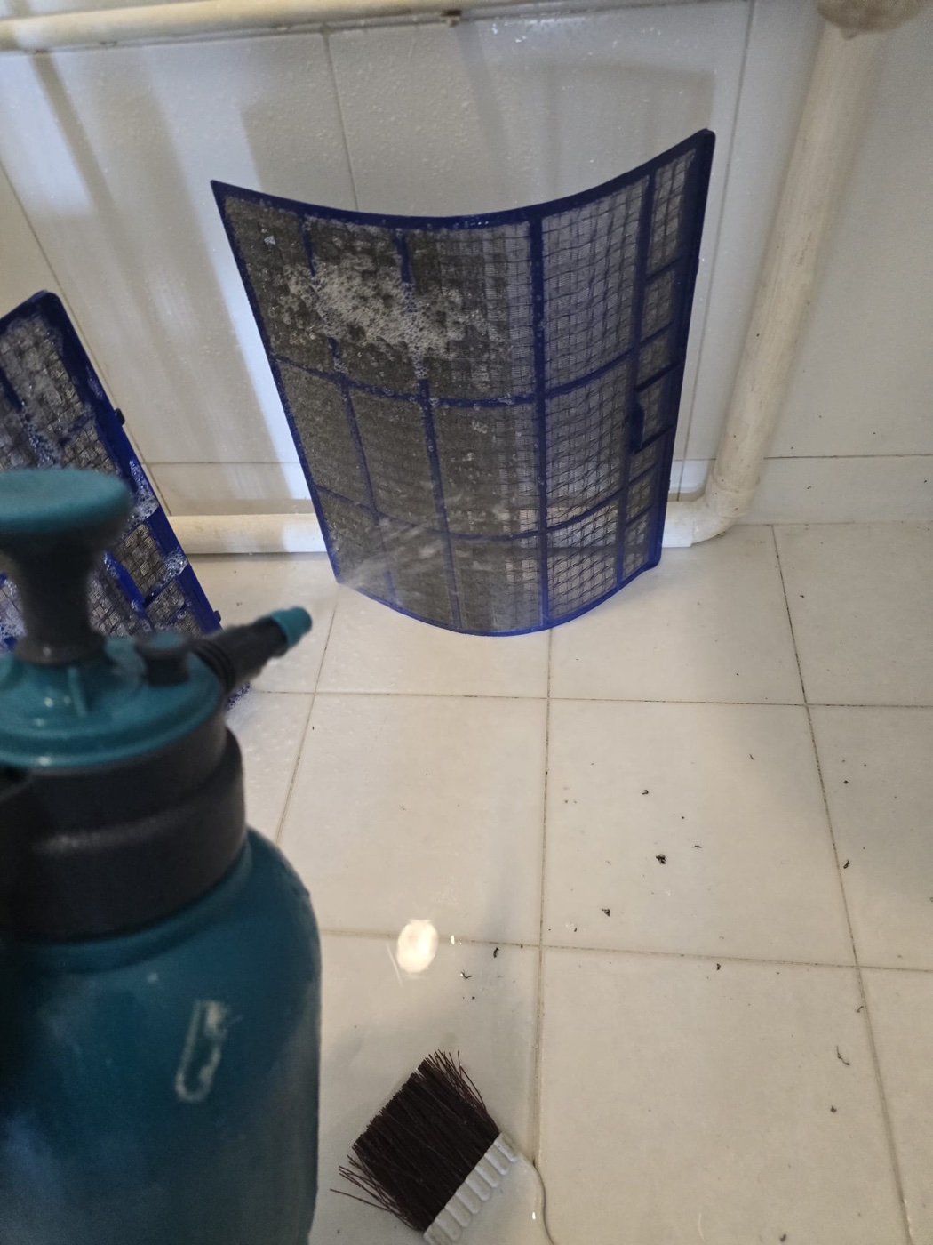 Aircon filter being washed during chemical overhaul